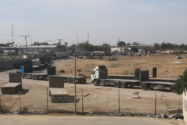 Palestinian trucks line up on the border to take humanitarian aid In Rafah (Hatem Ali/AP)
