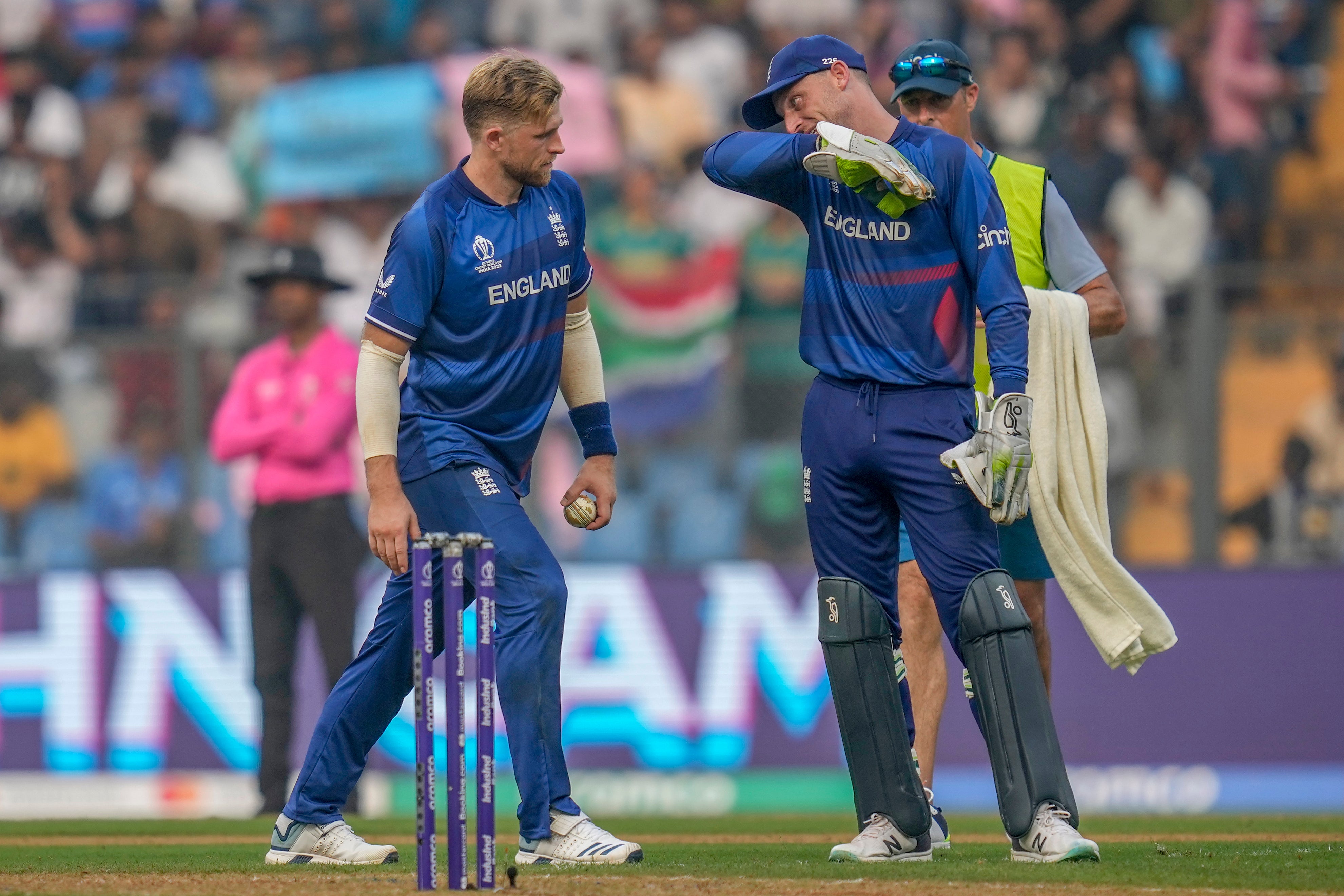 England's captain Jos Butler, right, talks to David Willey