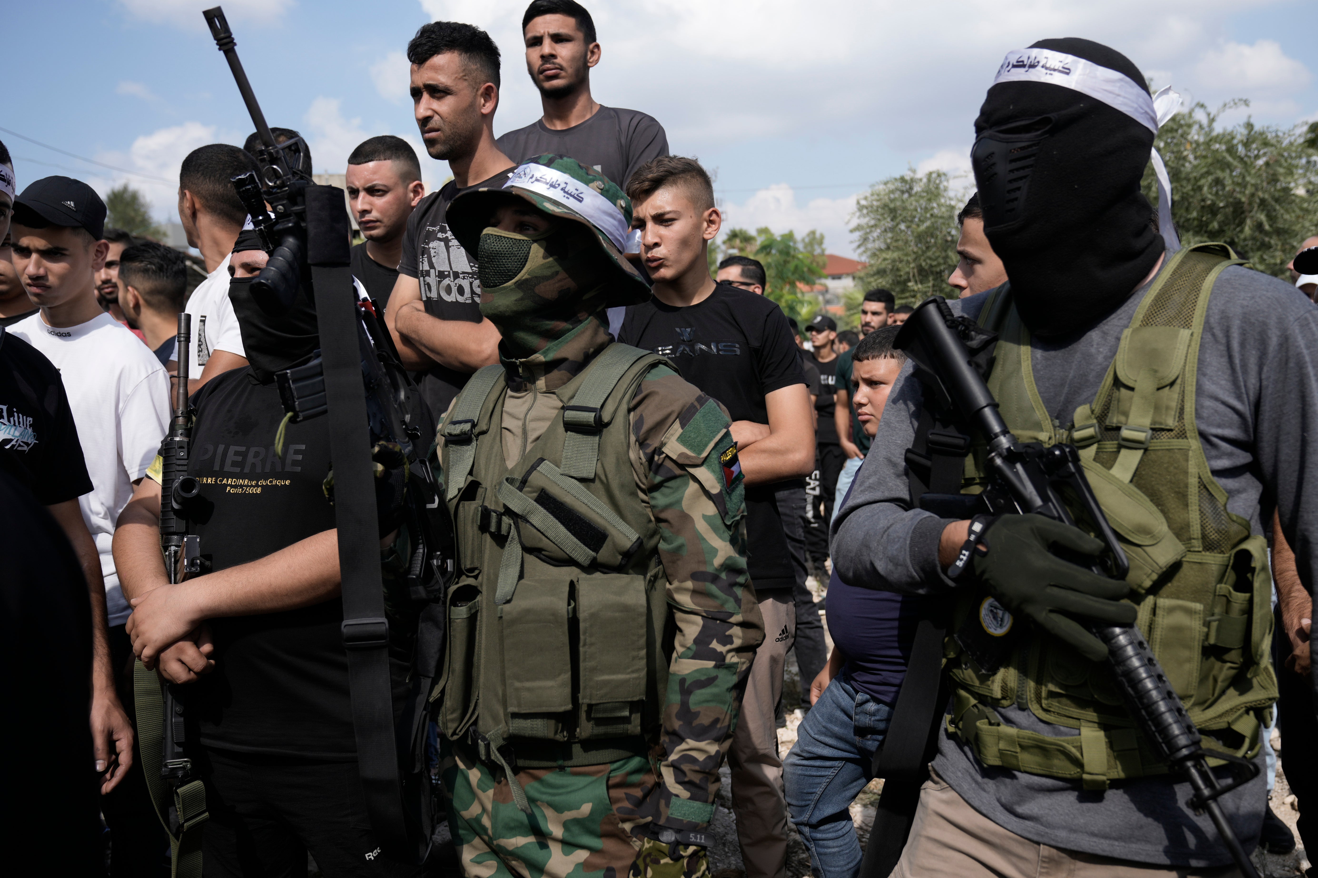Palestinian militants attend a funeral on Friday of people killed during an Israeli military raid on a Palestinian refugee camp, Nur Shams, in the West Bank