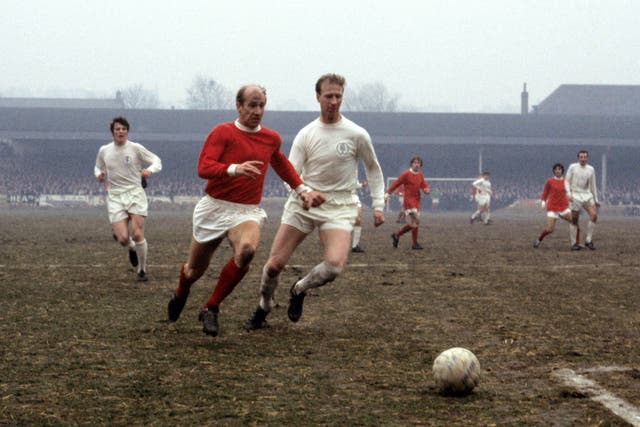Bobby Charlton in action against his brother Jack (PA).