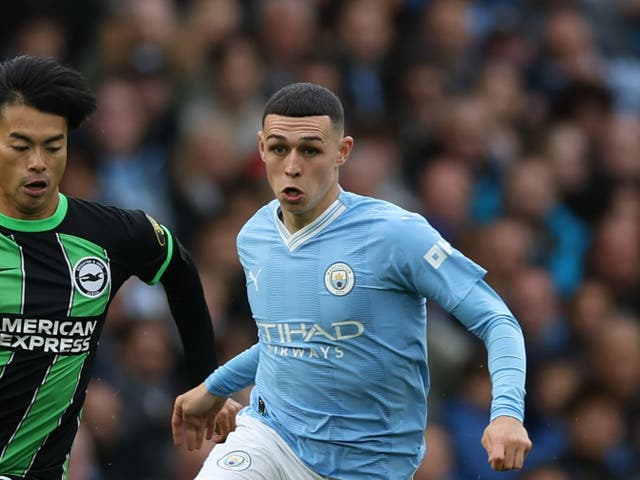 <p>Phil Foden of Manchester City in action against Kaoru Mitoma of Brighton</p>