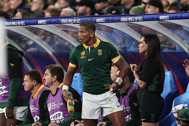 <p>South Africa's fly-half Manie Libbok (C) is seen on the bench after he was substituted</p>