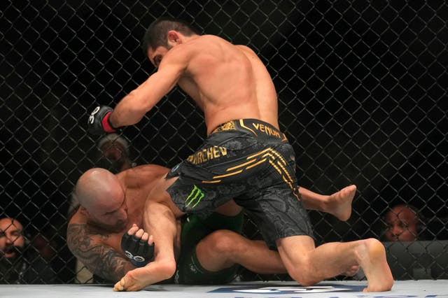 <p>Islam Makhachev, right, seals the finish against Alexander Volkanovski</p>