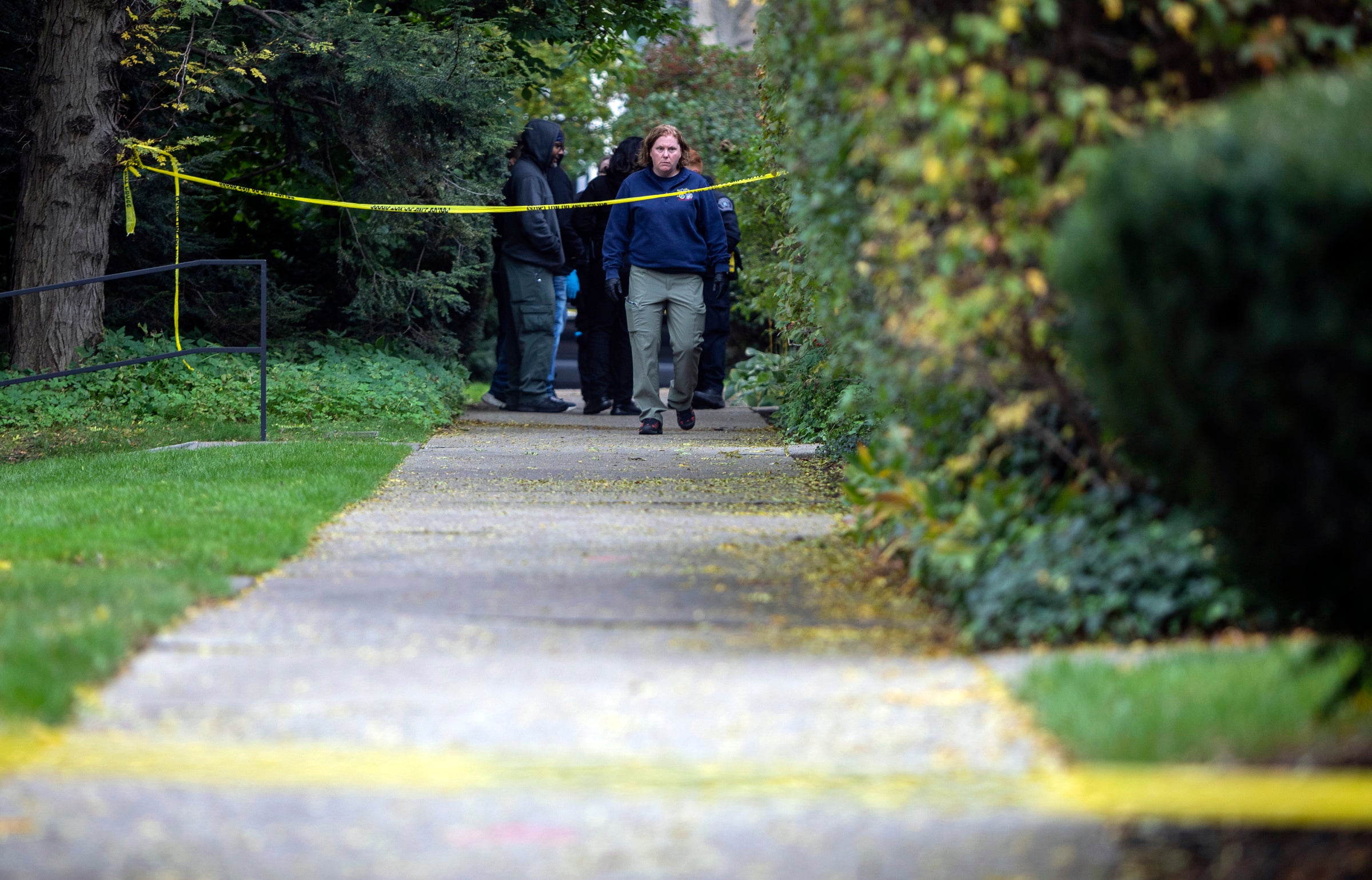 A law enforcement agent walks near the scene near the scene where a Detroit synagogue president, Samantha Woll, was foun