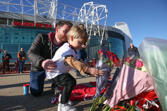 <p>Tributes are laid in memory of Sir Bobby Charlton outside Old Trafford (Barrington Coombs/PA)</p>