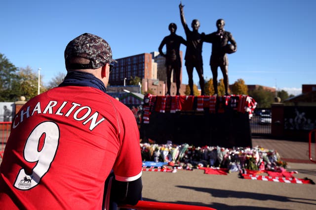 Tributes were laid in memory of Sir Bobby Charlton by the United Trinity statue at Old Trafford (Barrington Coombs/PA)