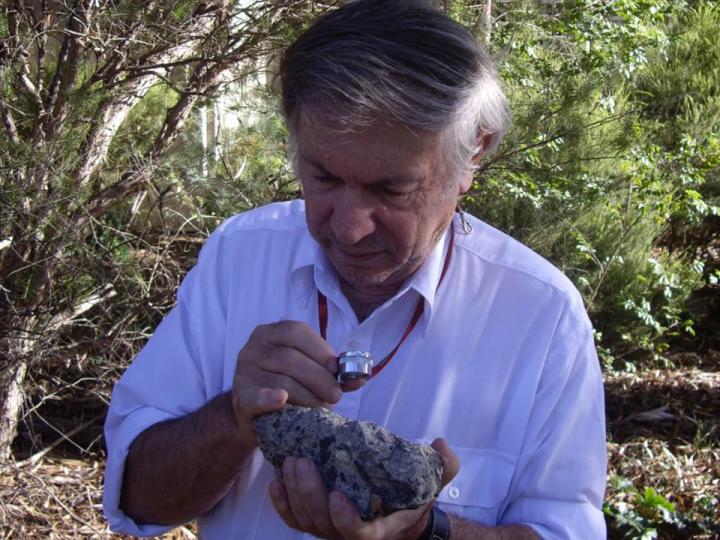 Andrew Glikson with a sample of suevite – a rock with partially melted material formed during an impact
