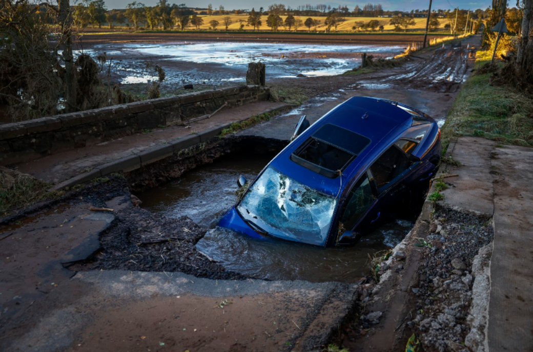 A different car is seen on bridge washed away following yesterday’s torrential rain on October 21, 2023 in Dundee