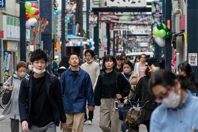 <p>Representational image: People walk past shops in Togoshi Ginza, one of the longest shopping streets in the capital Tokyo, on 8 May 2023</p>