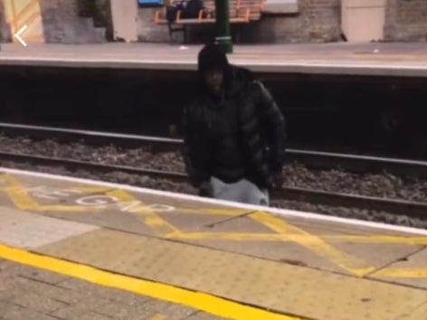 A viral video shows a man jumping over the train tracks to harass a woman