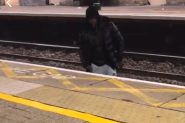 <p>The man jumped over the train tracks to harass the woman at a north London station </p>