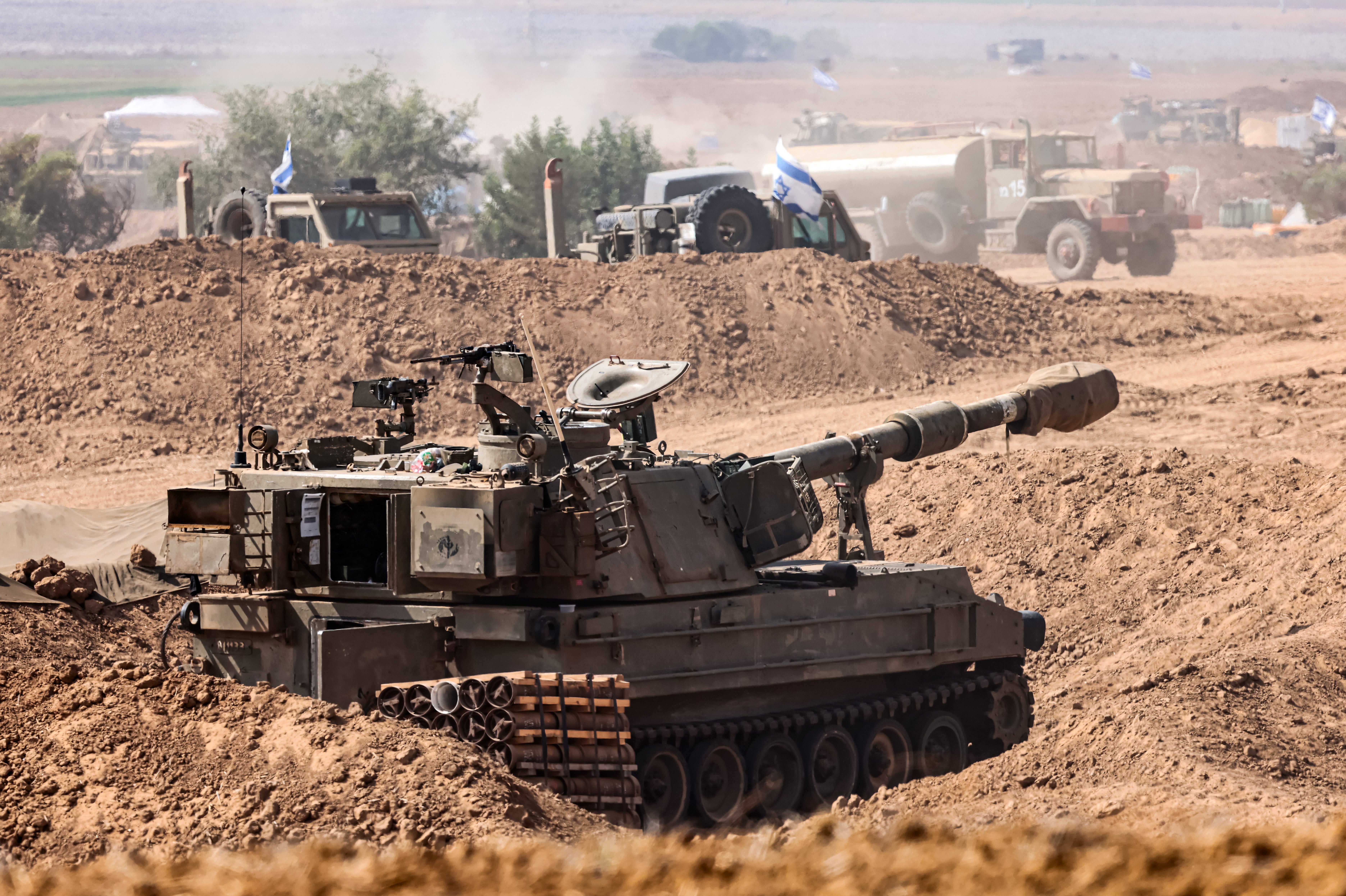 Israeli soldiers prepare for ground maneuvers at an undisclosed location near the border with Gaza