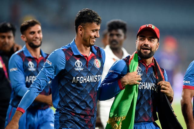 <p>Afghanistan's Mujeeb Rahman and Rashid Khan celebrate after winning the match by 8 wickets</p>