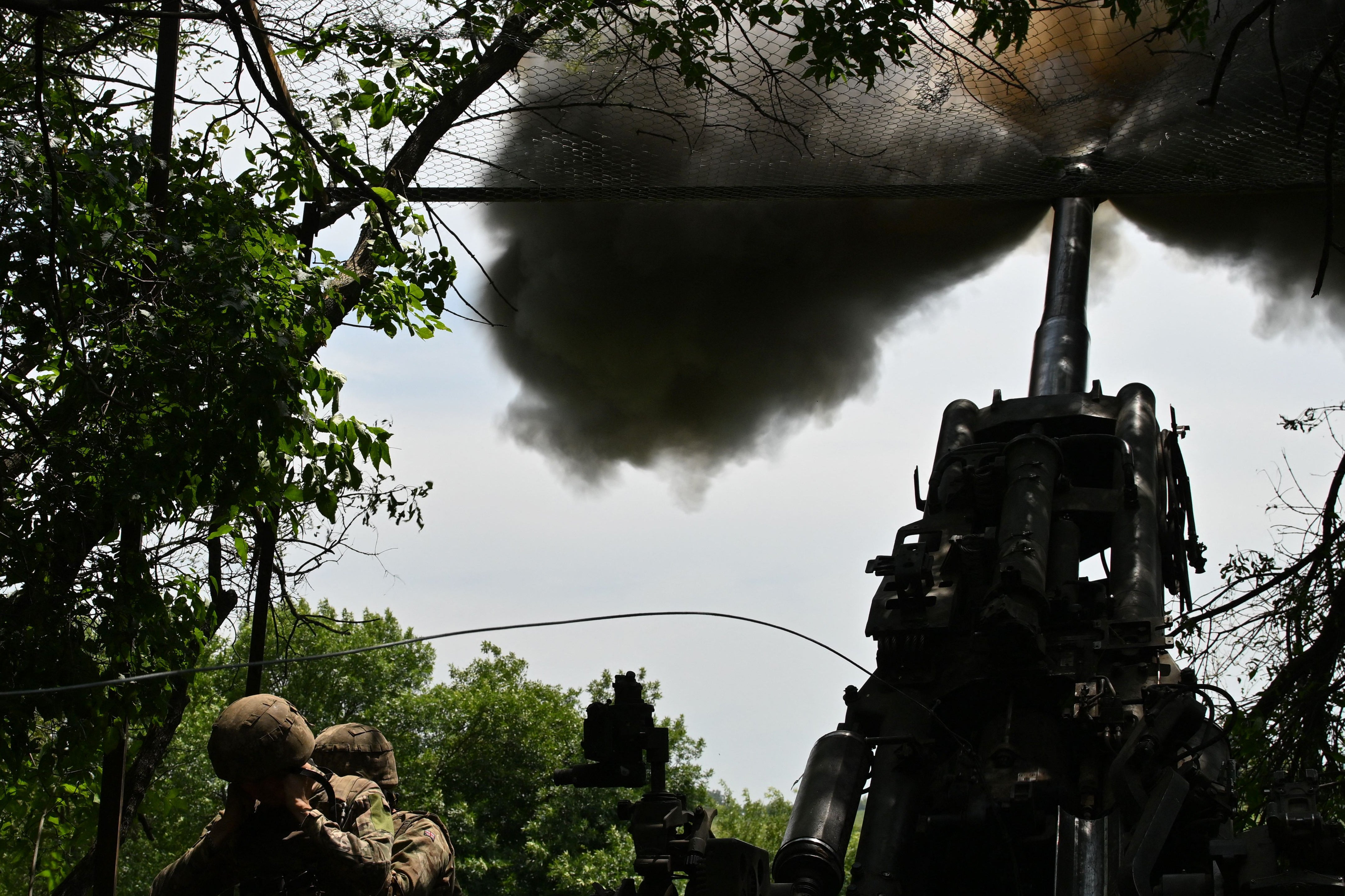 Ukrainian artillerymen fire an M777 howitzer towards Russian positions near Avdiivka