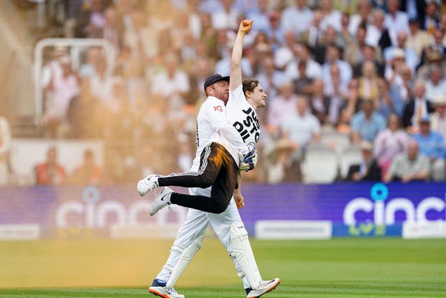 England’s Jonny Bairstow removes a Just Stop Oil protester from the pitch (Mike Egerton/PA)