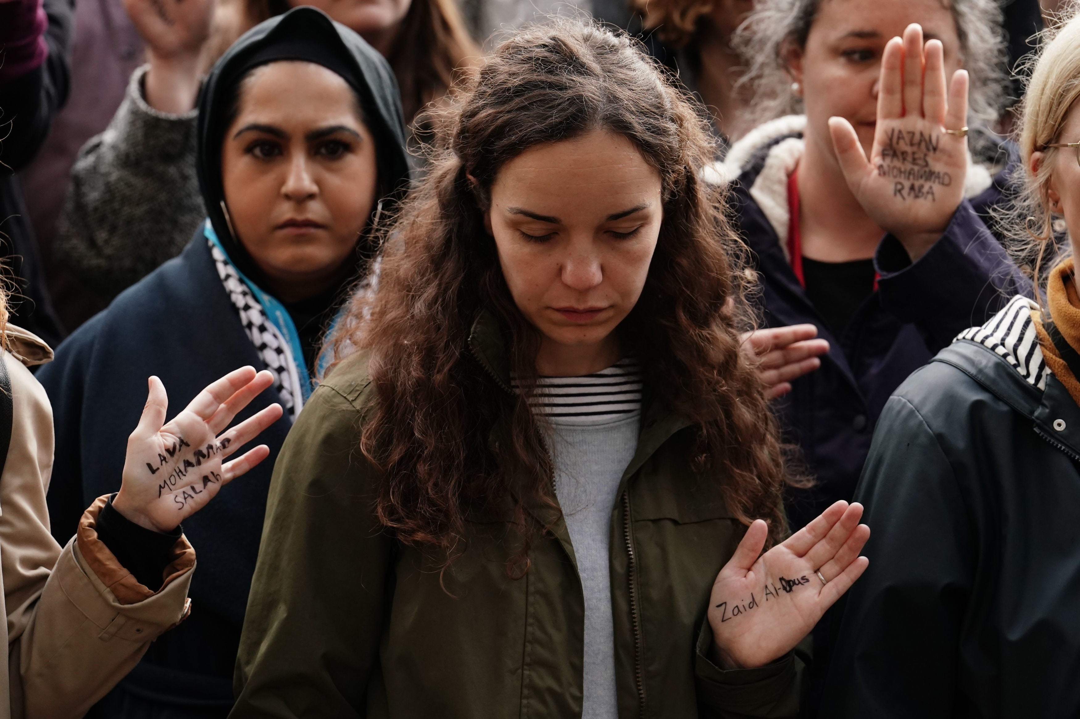 People take part in a vigil organised by Medical Aid for Palestinians at Parliament Square, central London