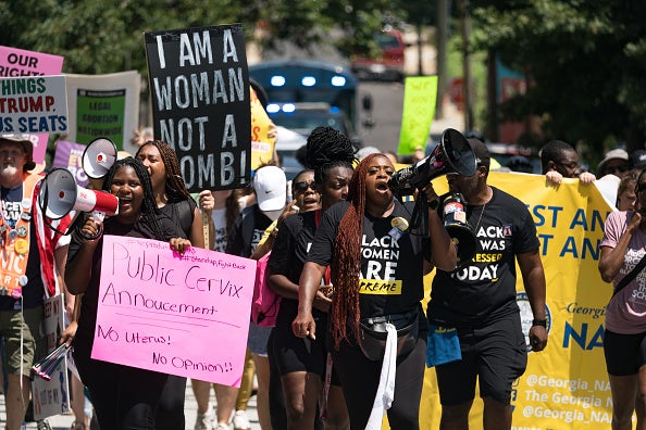 Protestors march and chant in Downtown Atlanta, in opposition to Georgia's new abortion law on July 23, 2022