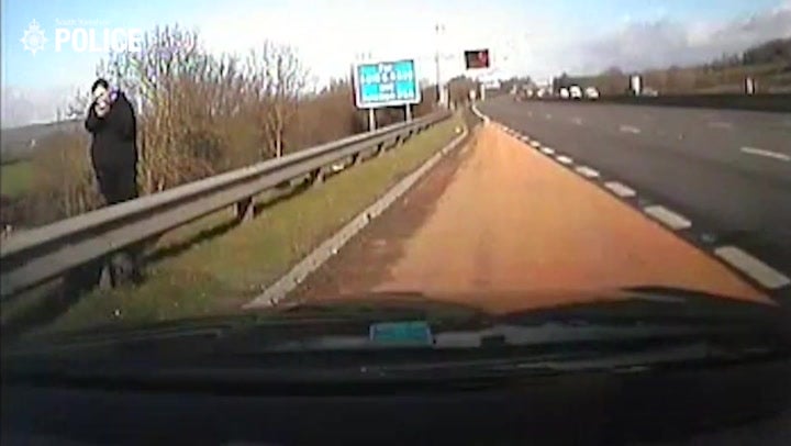 <p>Moment man pulls ‘gun’ on police officers as he wanders along busy M1.</p>