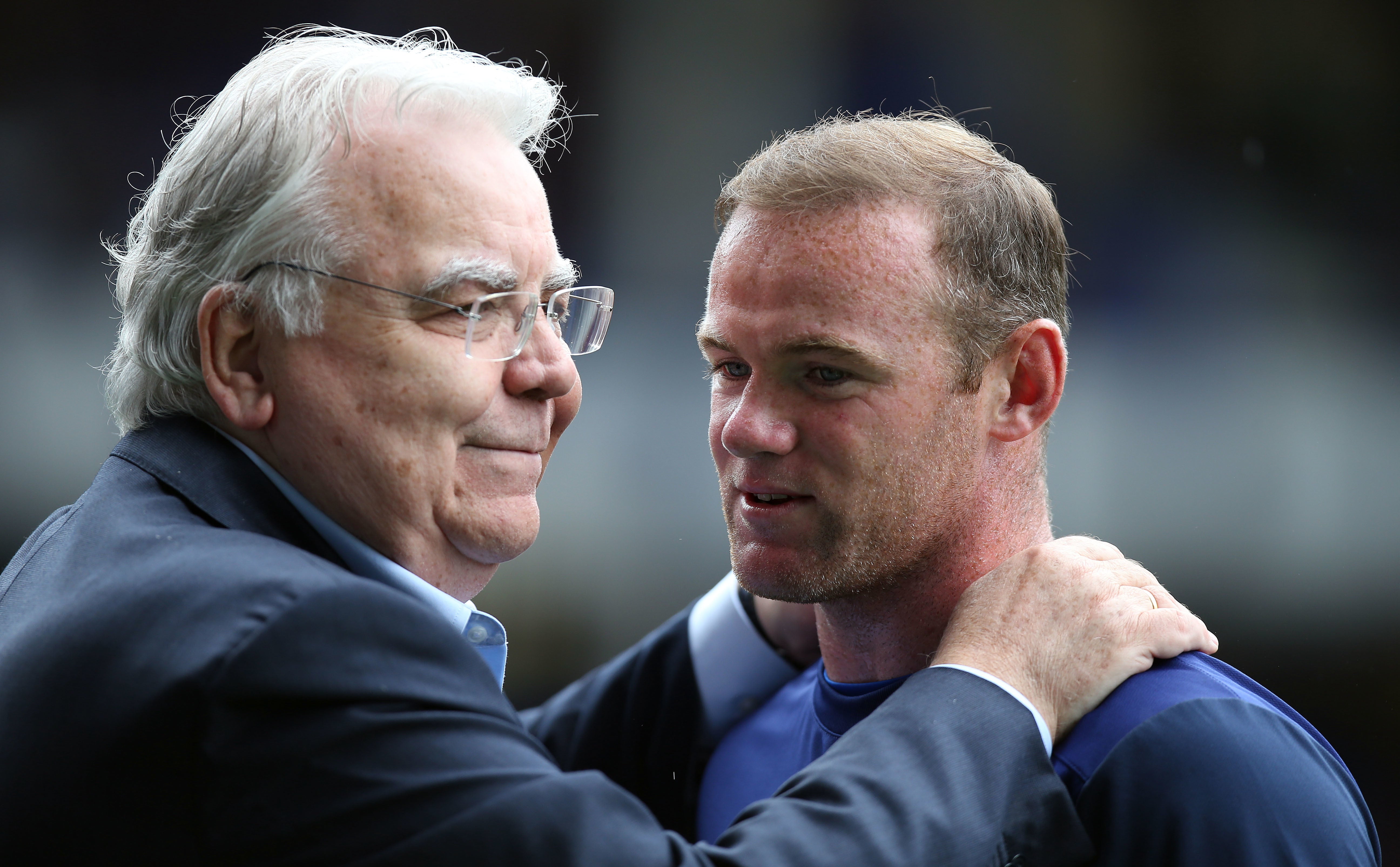 <p>Bill Kenwright embracing Everton’s Wayne Rooney</p>