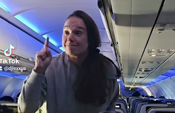 A woman was escorted off a JetBlue flight after berating a flight attendant