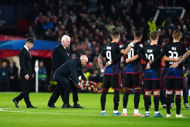 <p>Manchester United manager Erik ten Hag (centre) lays a wreath in tribute to Sir Bobby Charlton (Nick Potts/PA)</p>
