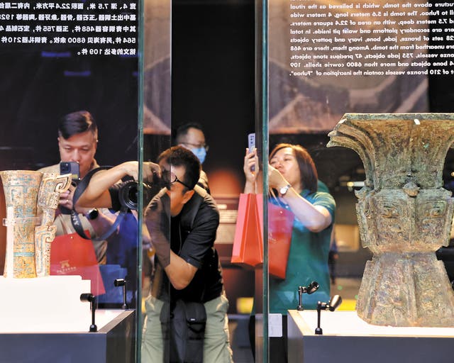 <p>Visitors take photos of cultural relics at the Chinese Archaeological Museum in Beijing, which opened to the public in September, 2023</p>