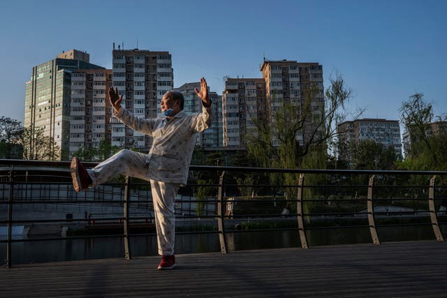 <p> A local man practices Tai Chi along the Liangma River on 19 April 2022 in Beijing, China</p>