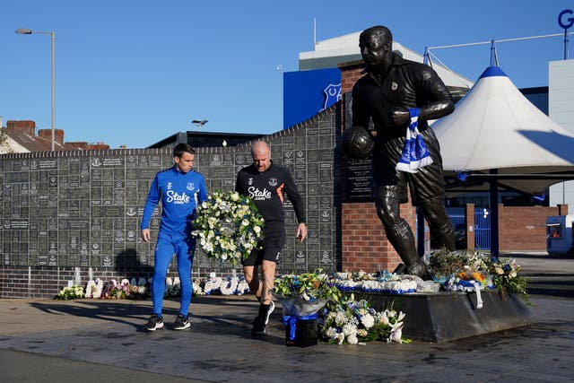 Everton captain Seamus Coleman and manager Sean Dyche lay flowers by the Dixie Dean statue outside Goodison Park in tribute to chairman Bill Kenwright (Peter Byrne/PA)