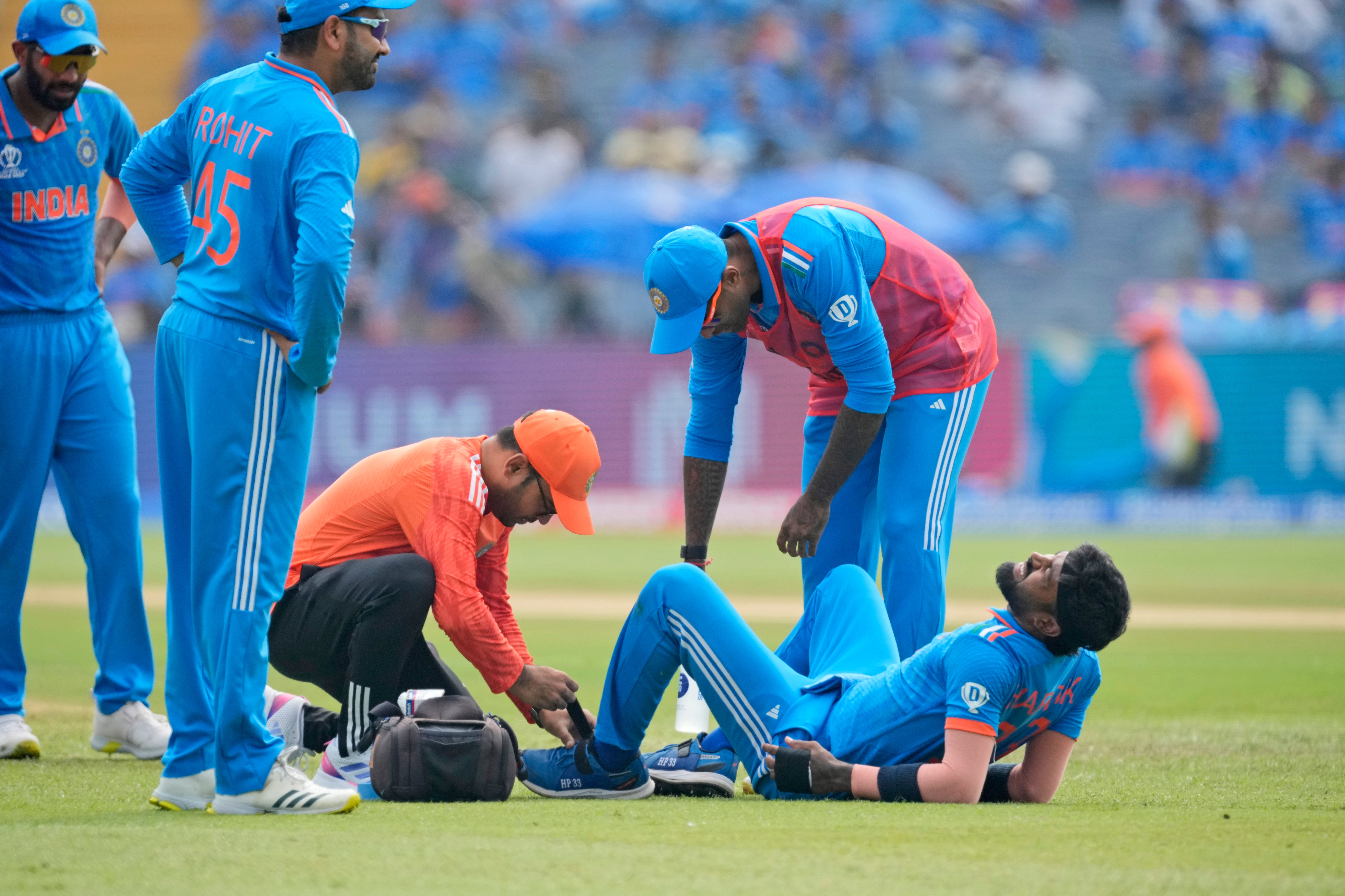 India’s Hardik Pandya receives medical treatment after being injured during the ICC Men’s Cricket World Cup match between India and Bangladesh on 19 October