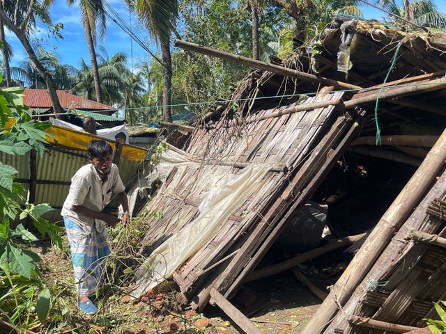 <p>A man inspects his damaged home in Cox’s Bazar on 25 October 2023, following the landfall of Cyclone Hamoon. Nearly 275,000 people in Bangladesh fled to shelters as Cyclone Hamoon barrelled into the southeastern coast, killing at least three people, officials said</p>