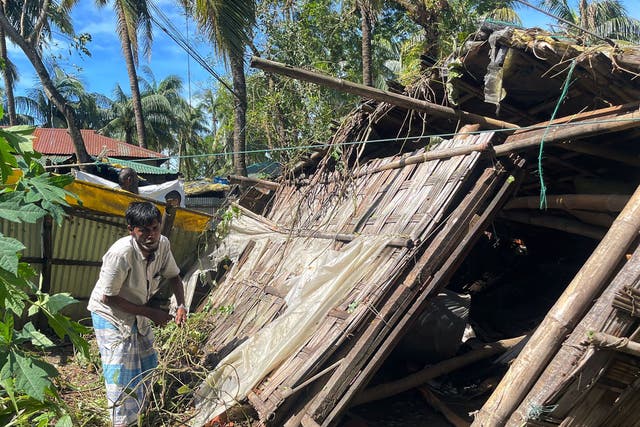 <p>A man inspects his damaged home in Cox’s Bazar on 25 October 2023, following the landfall of Cyclone Hamoon. Nearly 275,000 people in Bangladesh fled to shelters as Cyclone Hamoon barrelled into the southeastern coast, killing at least three people, officials said</p>