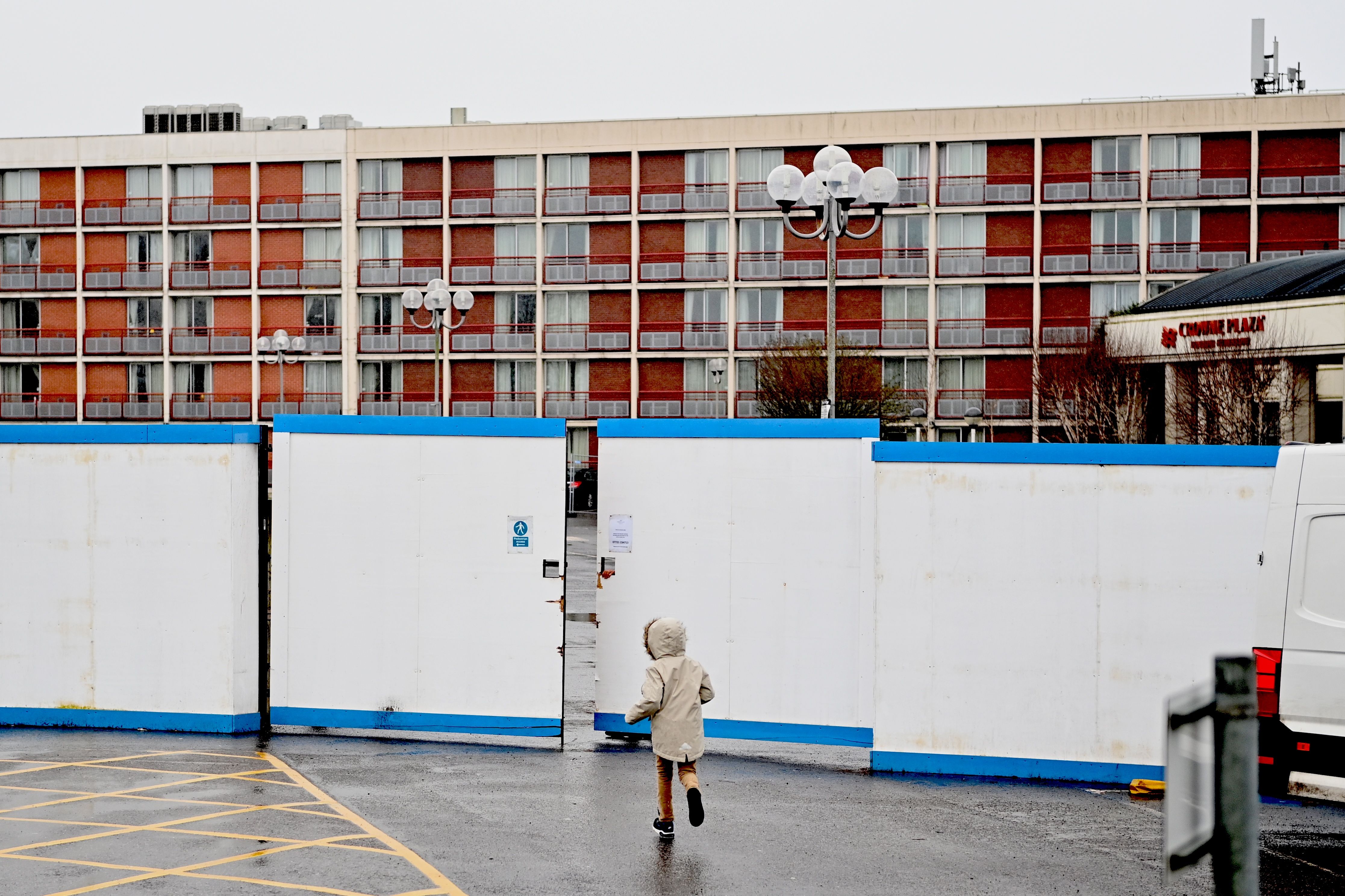 A child runs outside a hotel in Heathrow, west London, housing asylum seekers as they wait for their claims to be processed
