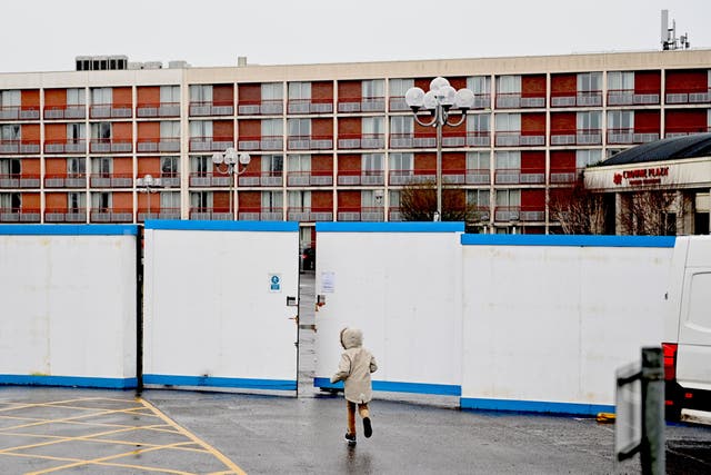 <p>A child runs outside a hotel in Heathrow, west London, housing asylum seekers as they wait for their claims to be processed</p>