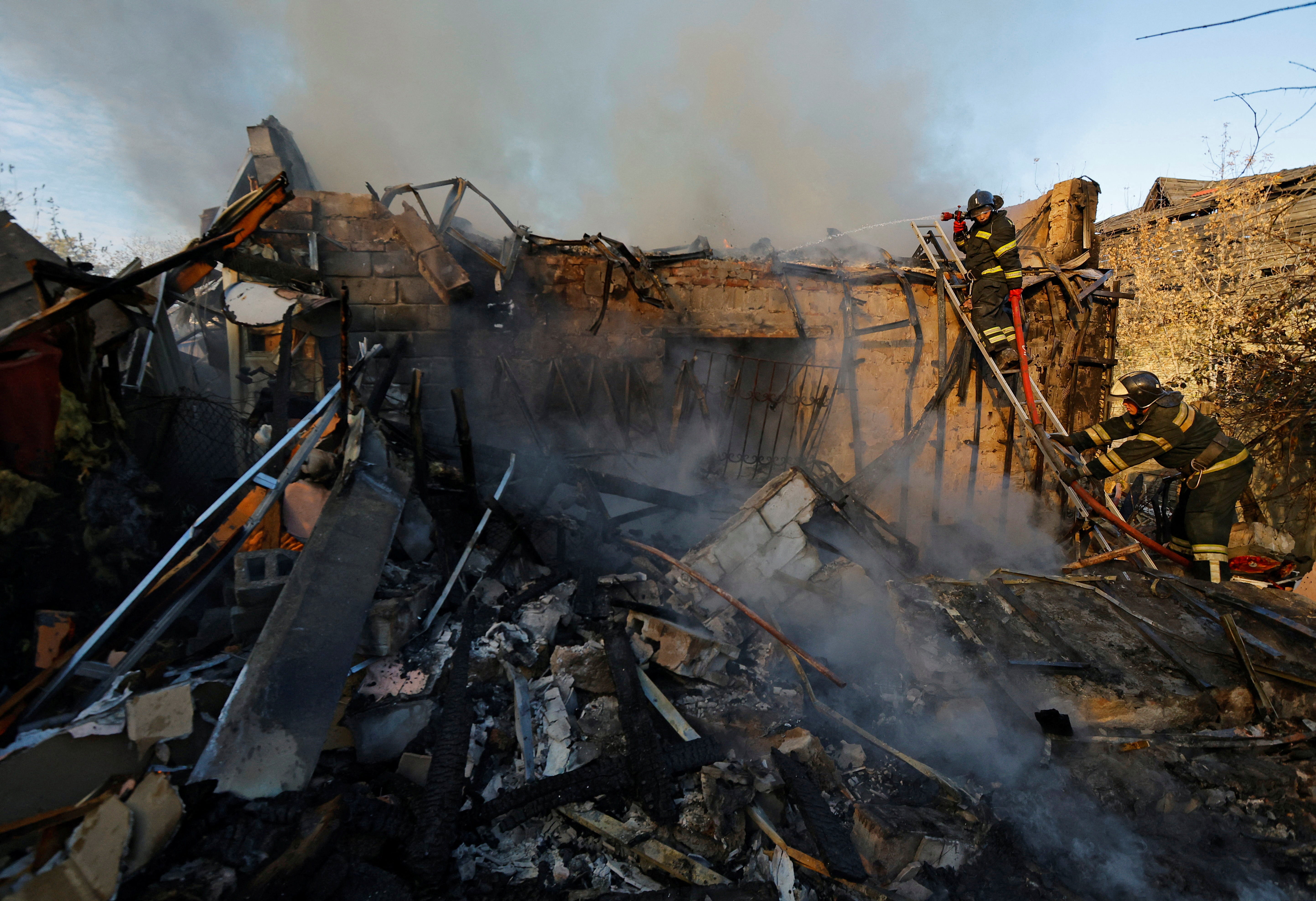 <p>File photo: Firefighters work to put out fire at a house that was hit by shelling in the course of Russia-Ukraine conflict in Donetsk, Russian-controlled Ukraine on 24 October</p>