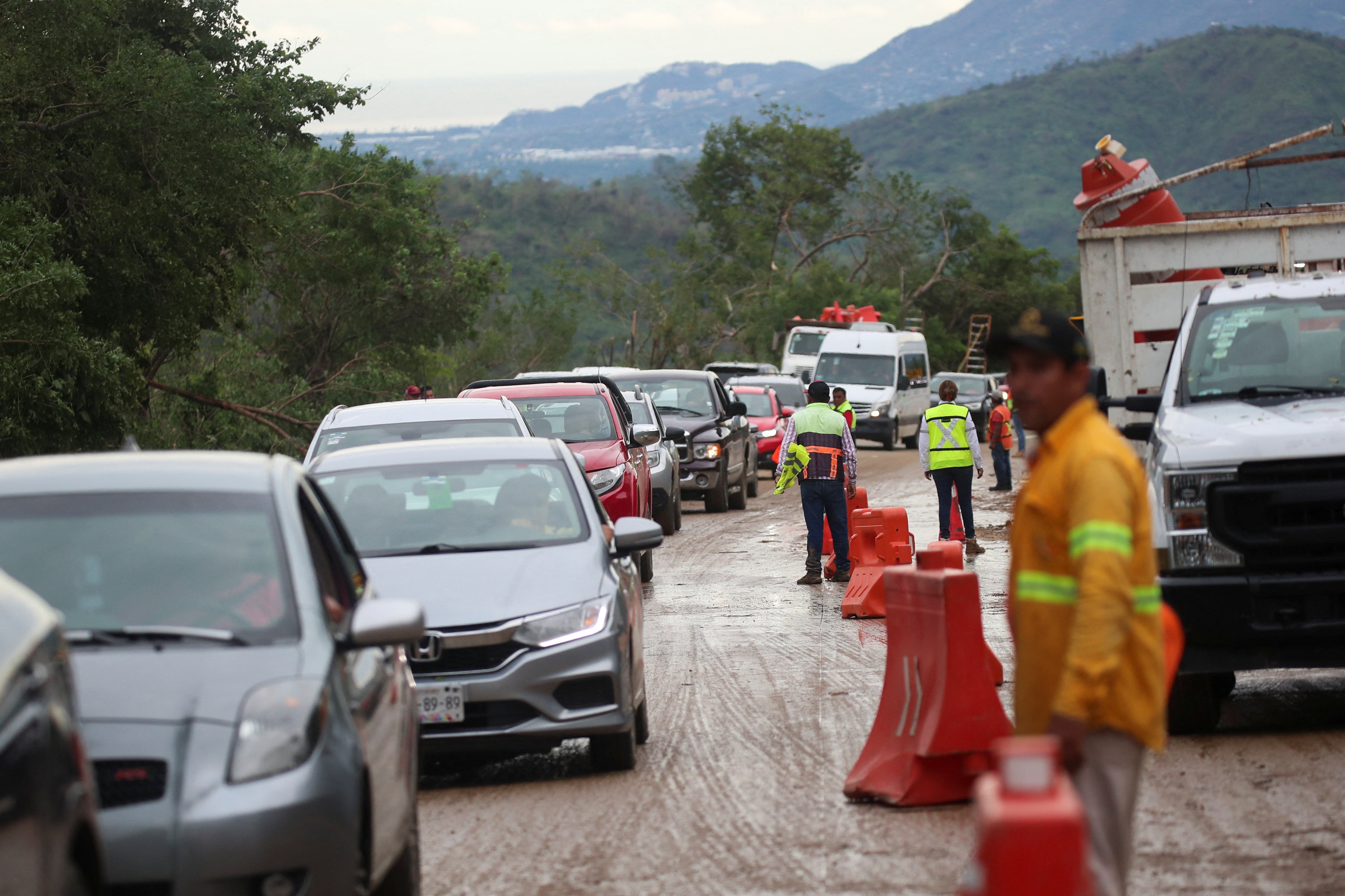 A view shows vehicles trapped by the landslide on parts of the route to Acapulco after Hurricane Otis hit, in the Mexican state of Guerrero