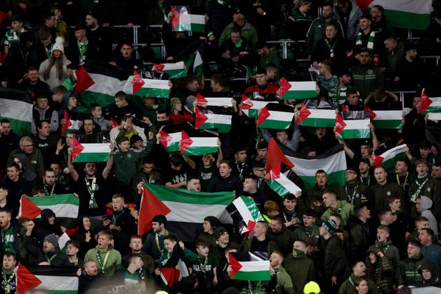 <p>Celtic fans hold Palestine flags aloft during Champions League match</p>