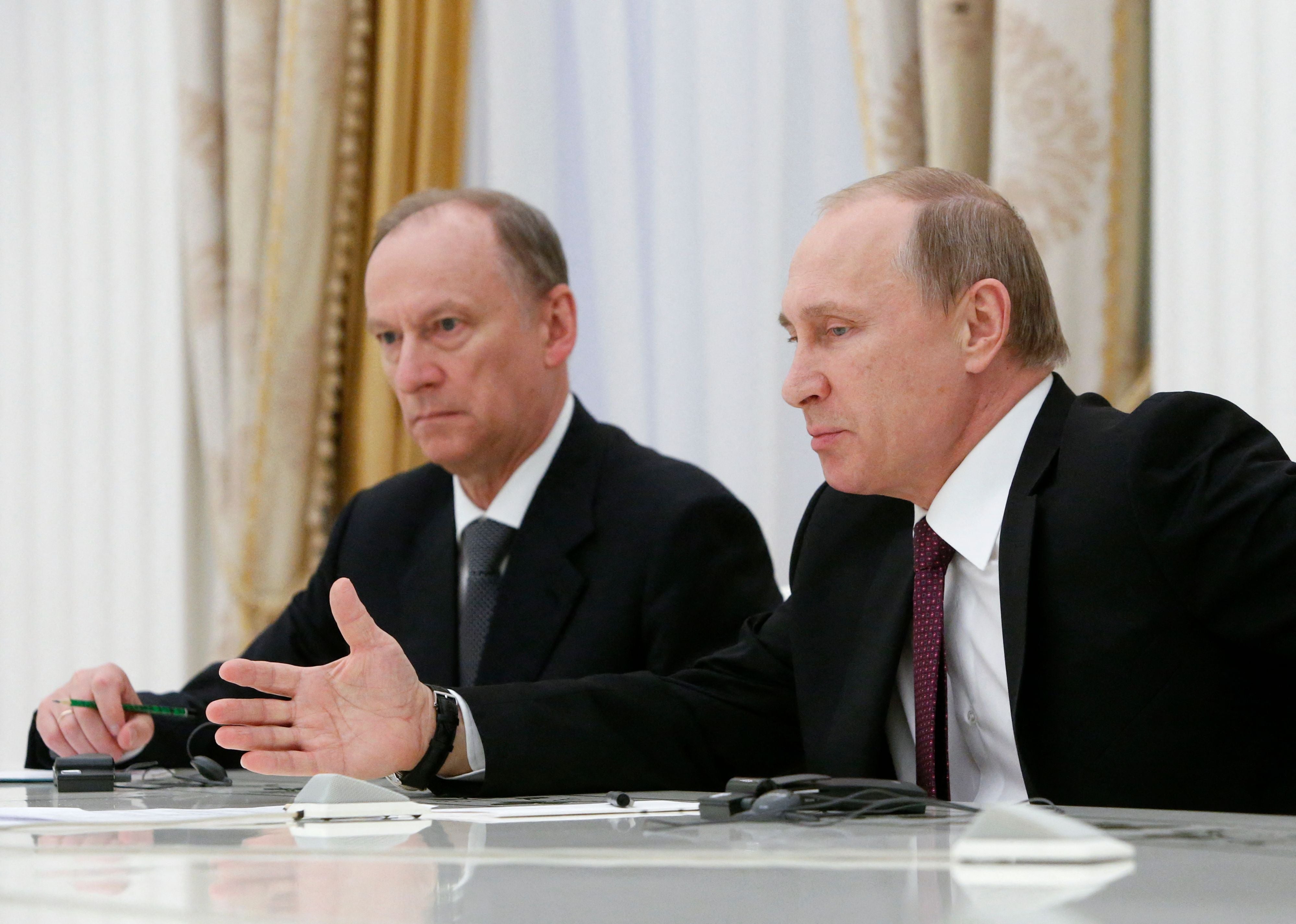 Nikolai Patrushev (left) was accused of personally overseeing the assassination of Yevgeny Prigozhin