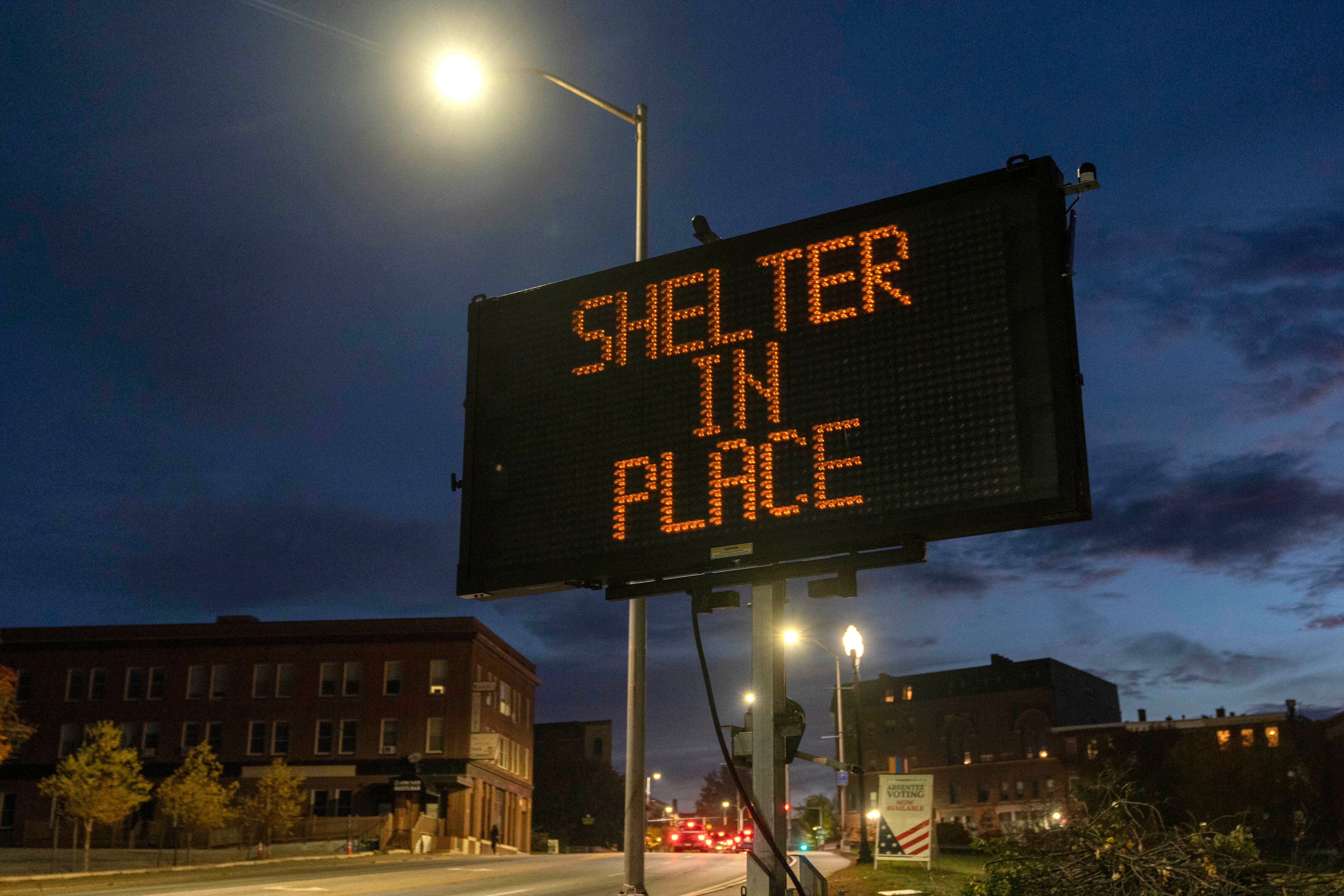 A sign advises residents to stay home and shelter in place