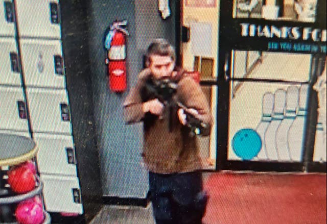 <p>A gunman enters Sparetime Recreation in Lewiston, Maine, on Wednesday</p>