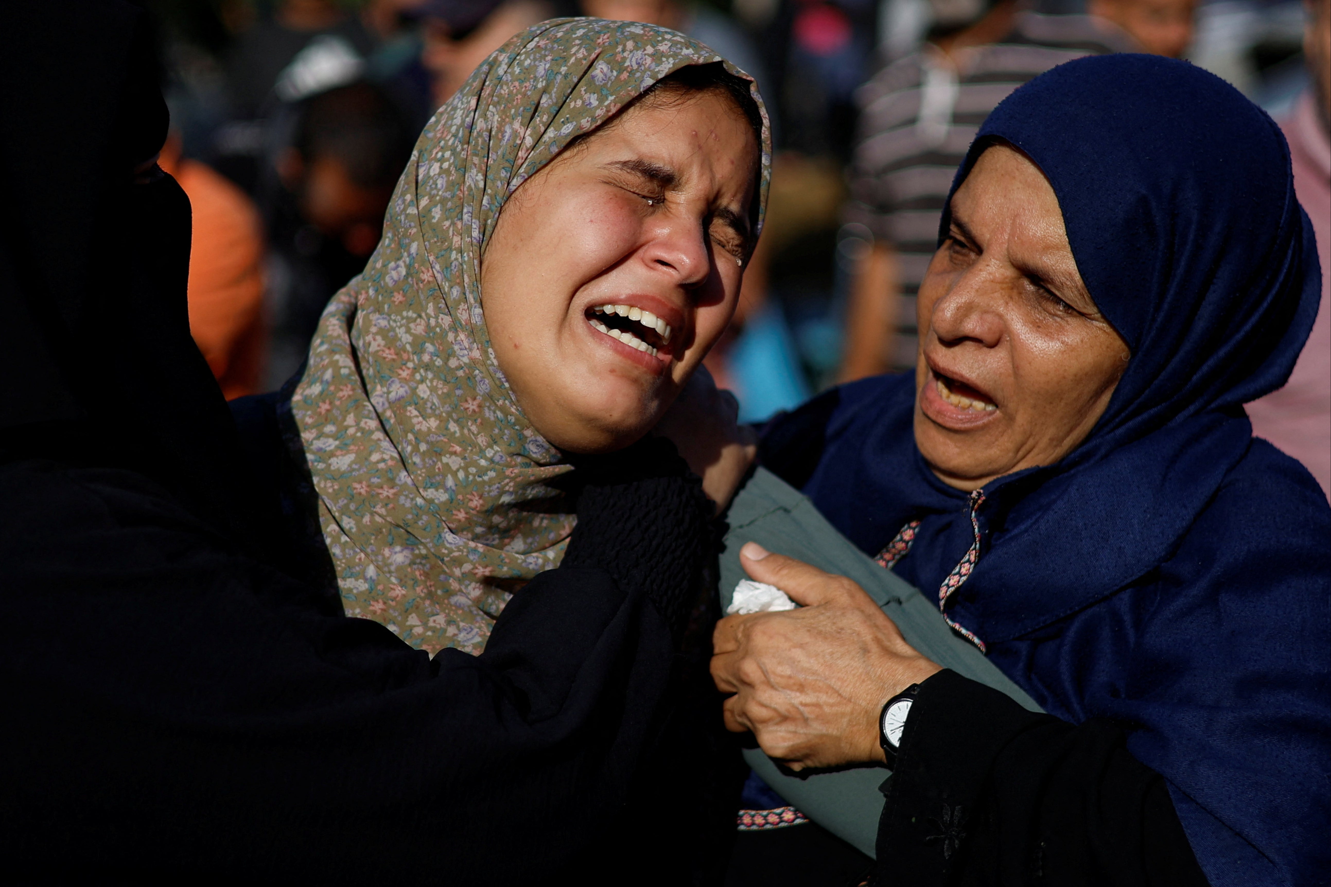 Women mourn during a funeral for Palestinians killed by Israeli strikes in southern Gaza