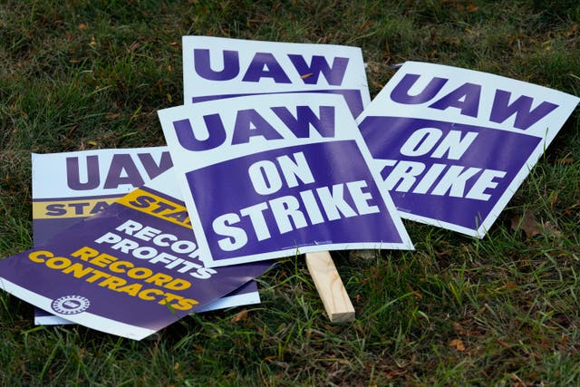 <p>United Auto Workers signs for a strike are shown at the Stellantis Sterling Heights Assembly Plant, in Sterling Heights, Mich., Monday, Oct. 23, 2023</p>