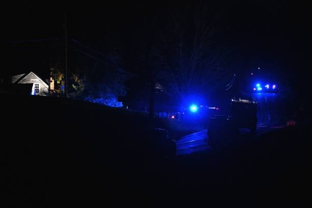 <p>Law enforcement are seen outside the home of suspect Robert Card’s father and brother in Bowdoin, Maine on 26 October 2023</p>