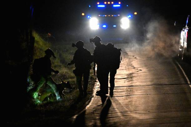 <p>Law enforcement are seen outside the home of suspect Robert Card’s father and brother in Bowdoin, Maine on 26 October 2023</p>