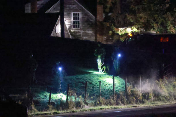 <p> Law Enforcement officials search an area for a suspect in connection with two mass shootings on 26 October 2023 in Bowdoin, Maine</p>