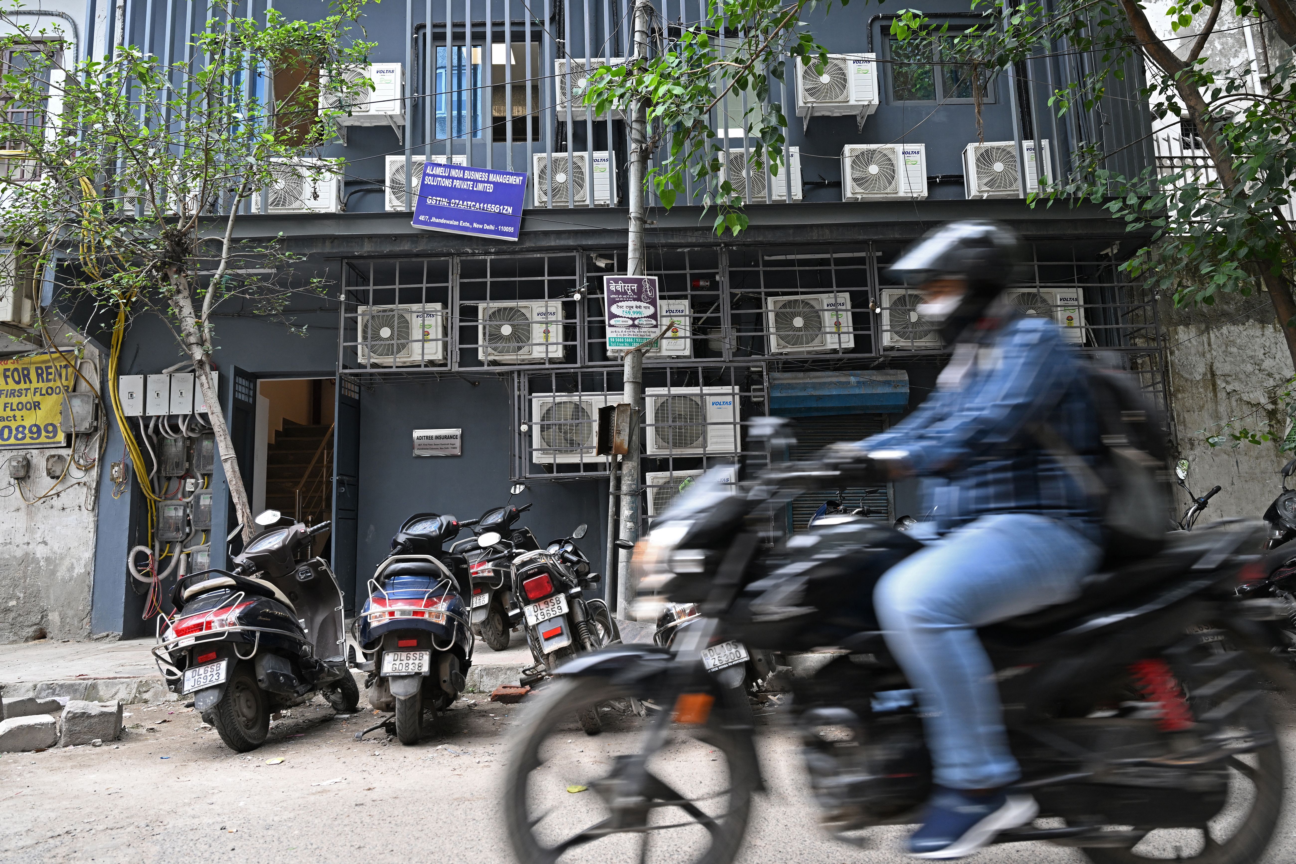 <p>A commuter rides past a building with airconditioning units on its facade in New Delhi.  India’s electricity consumption for household air conditioners is expected to increase nine-fold by 2050</p>
