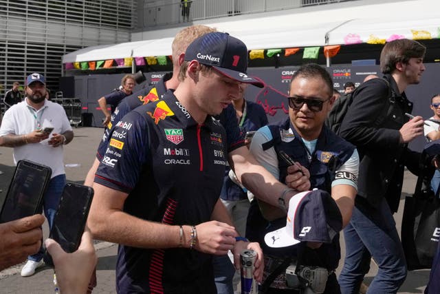 Max Verstappen is mobbed in the Mexico City paddock (Fernando Llano/AP)