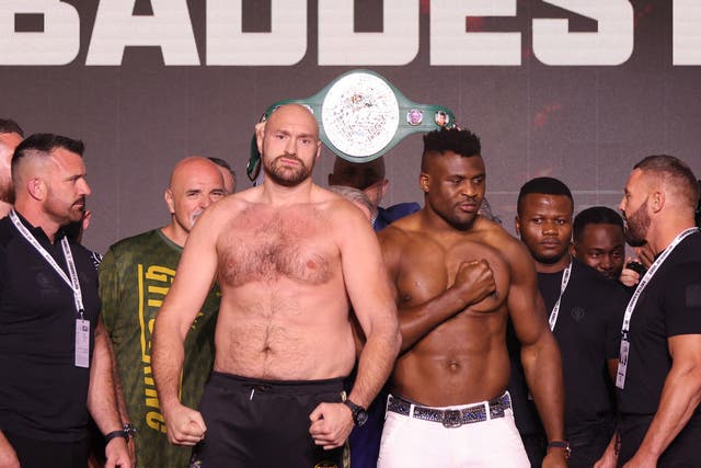 <p>Tyson Fury, centre left, and Francis Ngannou after weighing in</p>
