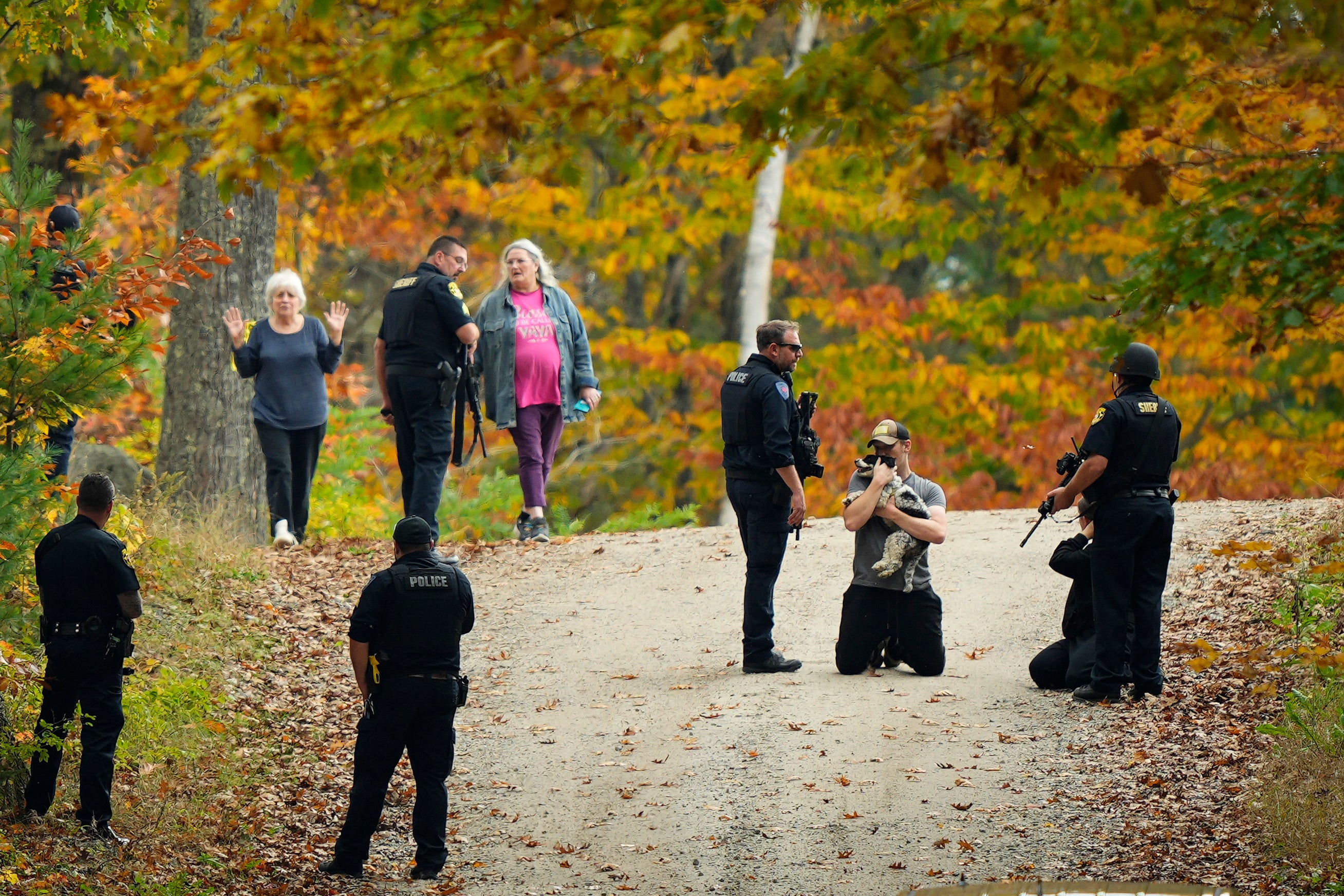 Police temporarily detain residents on Friday as they hunt for the suspect in Wednesday’s mass shooting in Maine, USA