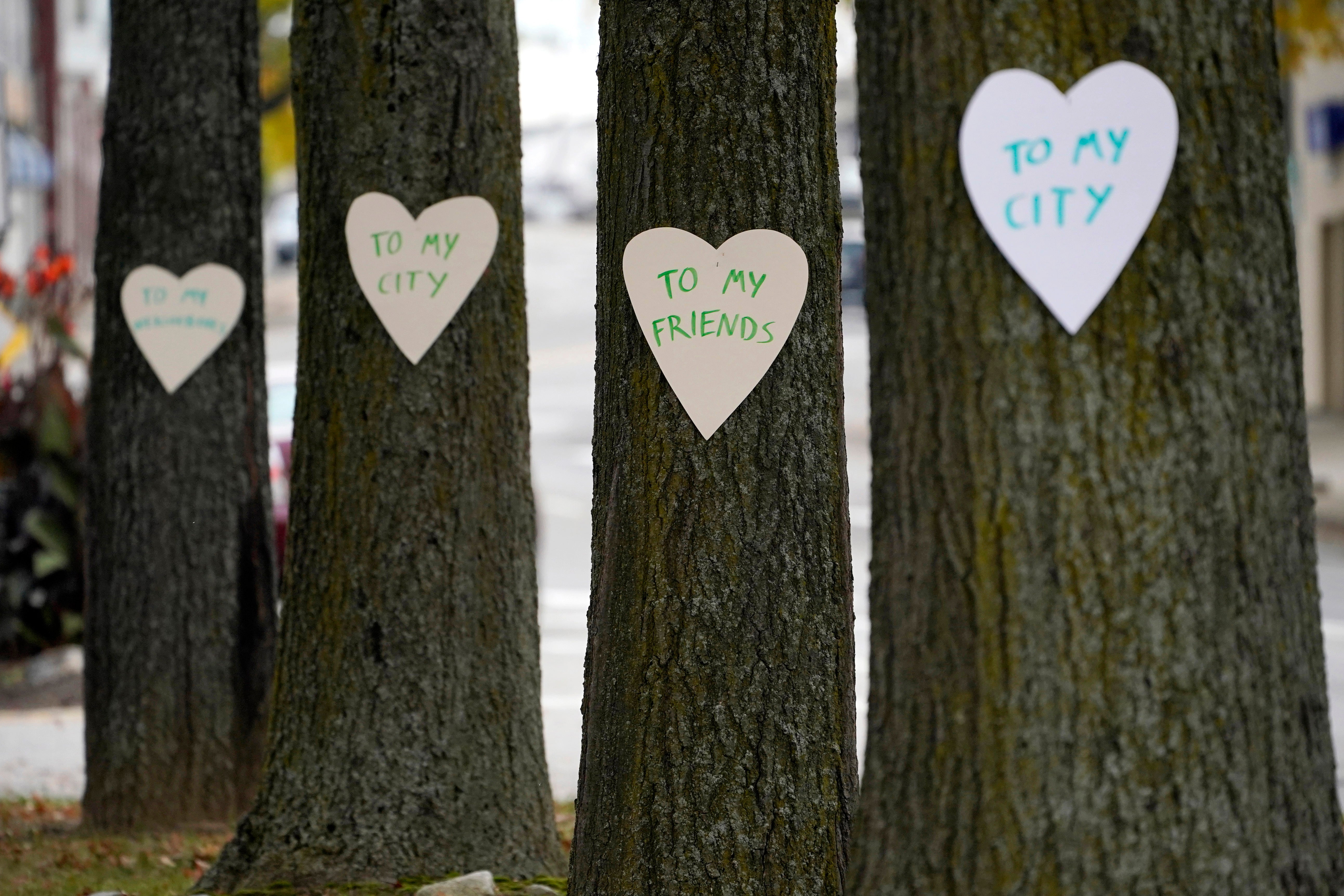 Heart-shaped cut-outs with messages of positivity adorns trees in downtown Lewiston, Maine, Thursday, Oct. 26, 2023. The...