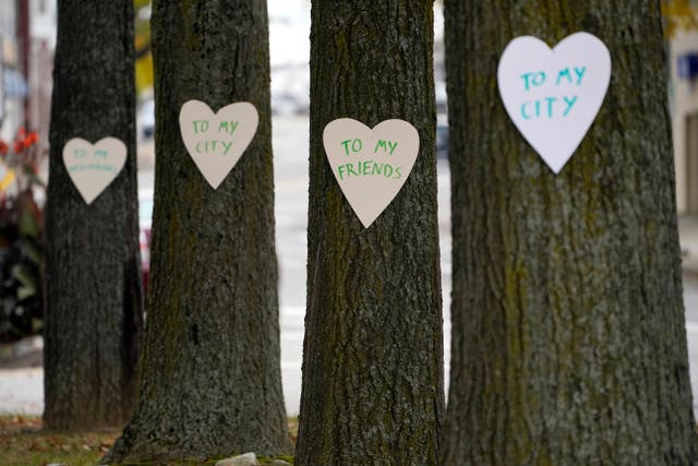 <p>Heart-shaped cut-outs with messages of positivity adorns trees in downtown Lewiston, Maine, Thursday, Oct. 26, 2023. The...</p>